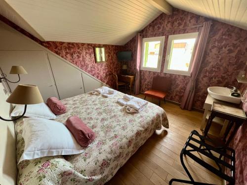 a bedroom with a bed and a sink in it at Hotel Le Ponteil in Antibes