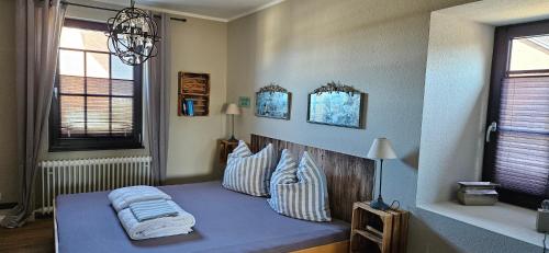 a bedroom with a blue bed with pillows on it at Haylees Hus 2 in Kellenhusen