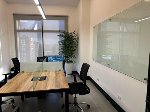 an office with a table and chairs and a window at Bonn 10 in Estación Pamplona