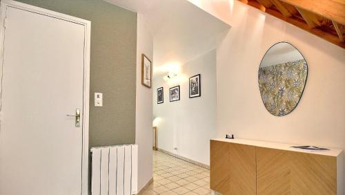 a bathroom with a sink and a mirror on the wall at Gîte de l Archange in Josselin