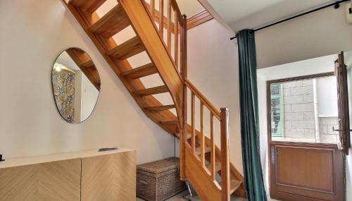a wooden staircase in a room with a mirror at Gîte de l Archange in Josselin