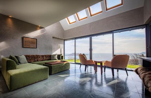 a living room with a couch and a table and chairs at Flodigarry Hotel in Staffin