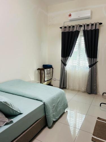 a bedroom with a bed and a window at Sofea Homestay Ipoh V2 in Ipoh