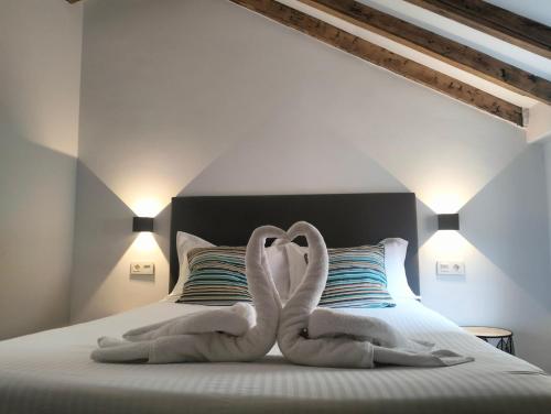a bed with two pairs of socks on it at Gran Via 16 Bilbao centro LBI00574 in Bilbao