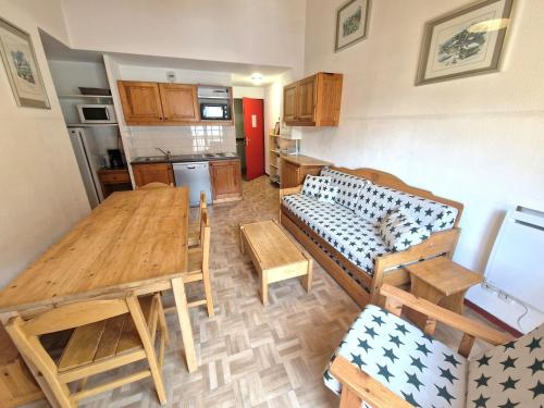 - une cuisine avec une table et un canapé dans une chambre dans l'établissement Bel appartement 3 pièces 6/7 pers. - 150m des pistes, 300m du centre - Modane - FR-1-265-304, à Modane
