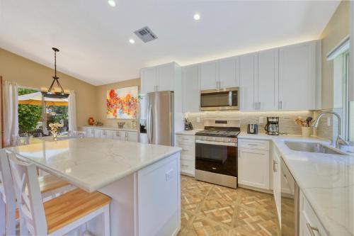a kitchen with white cabinets and a counter top at Casitas Del Sol in Cathedral City