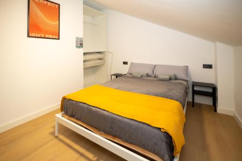 a bedroom with a large bed in a white room at Carthago Suites - Puerto in Cartagena