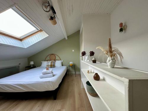 - une chambre mansardée avec un lit et une lucarne dans l'établissement Le Bohème - Duplex - 2 à 4 personnes - Proche Gare, à Nancy