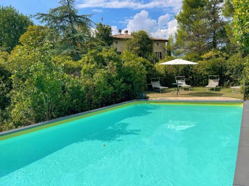 a swimming pool in front of a house at Adam House - beautiful exc Pool - sleeps 8 in Marzolini