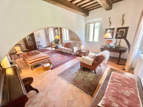 a living room filled with furniture and a large archway at Adam House - beautiful exc Pool - sleeps 8 in Marzolini