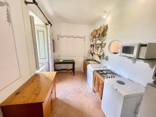a kitchen with a white stove and a microwave at Adam House - beautiful exc Pool - sleeps 8 in Marzolini