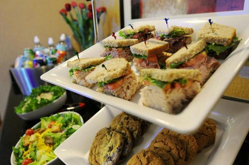 a group of sandwiches and salad and cookies on a shelf at Courtyard by Marriott Dallas Plano Parkway at Preston Road in Plano
