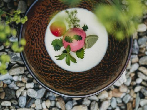 a plate with some tomatoes on a table at Hotel Muhr in Pöllauberg