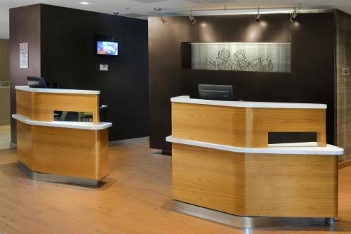a lobby with two reception desks in a building at Courtyard by Marriott Dallas Plano Parkway at Preston Road in Plano