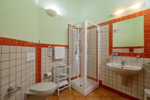 a bathroom with a toilet and a sink and a shower at Club Esse Cala Gonone in Cala Gonone