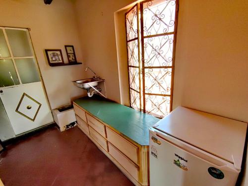 a kitchen with a refrigerator and a window at Mudejar in Morelia