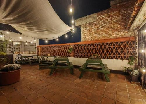a patio with picnic tables in a restaurant at Mudejar in Morelia