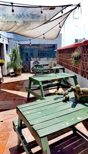a group of picnic tables on top of a roof at Mudejar in Morelia