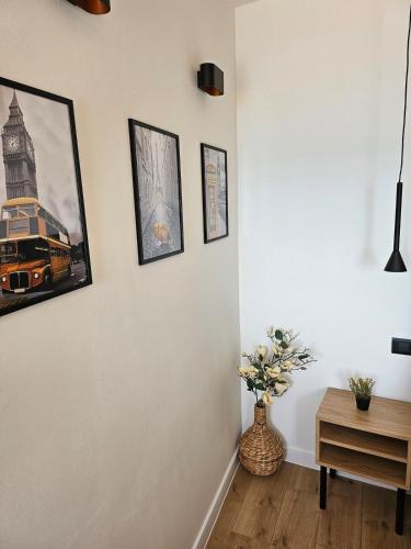 a room with a vase of flowers and pictures on the wall at Studio Sea view in Bol