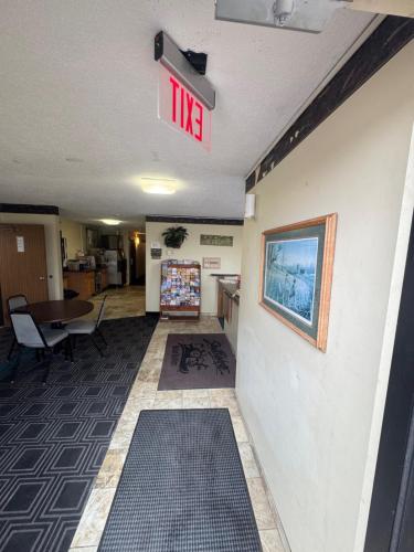 a waiting room with a sign on a wall at Smart Choice Inn in Plankinton