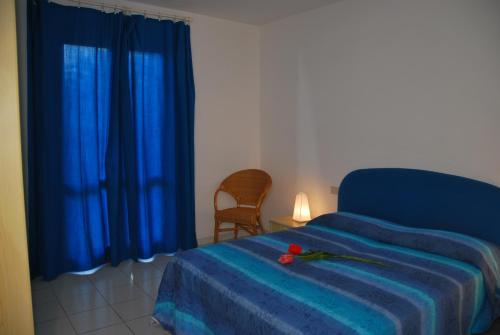 Ένα ή περισσότερα κρεβάτια σε δωμάτιο στο Casa Vacanze Rosa dei Venti - Clima, terrazze e biciclette