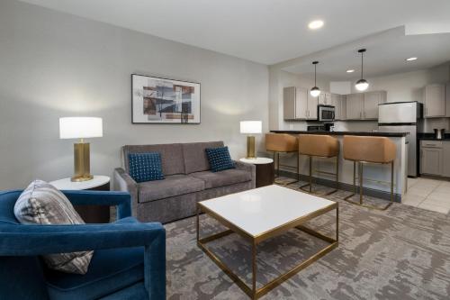 a living room with a couch and chairs and a table at Hilton Promenade Branson Landing in Branson