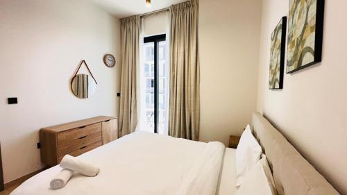a bedroom with a bed and a window at OYO 1292 Home Fully Furnished 1bed Apt @JVC in Dubai