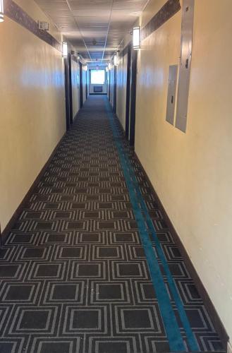 a hallway in an office building with a carpeted floor at Smart Choice Inn in Plankinton