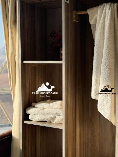 a closet with some towels in a room at Wadi Rum ZAAD luxury Camp in Disah