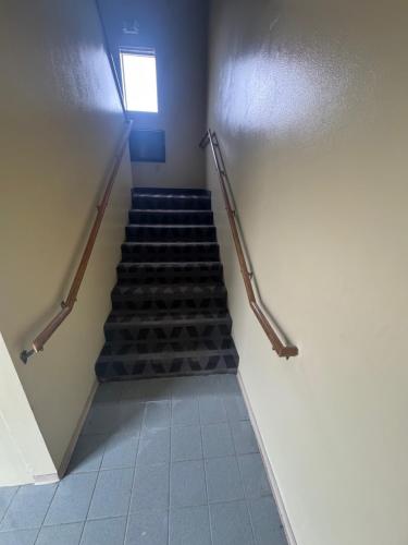 a staircase in a building with a stair case at Smart Choice Inn in Plankinton