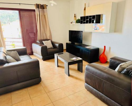 a living room with two couches and a coffee table at Quarto de Casal Privativo- Room 1 in Santa Cruz