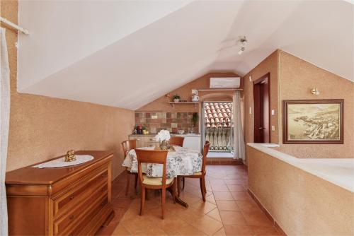 a kitchen and dining room with a table and chairs at G-Apart in Kotor