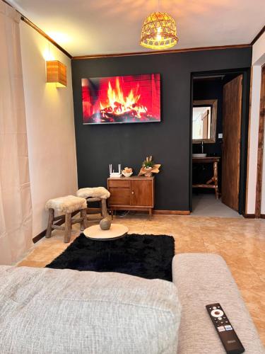 a living room with a couch and a fire on the wall at Depto CENTRICO AURA in Río Gallegos