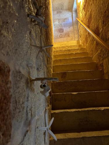 a set of stairs with stars on the wall at Don Nicola Tourist Location in Polignano a Mare