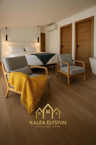 a bedroom with two beds and a couch and a chair at Kalea Elysivm in Alcalá del Júcar
