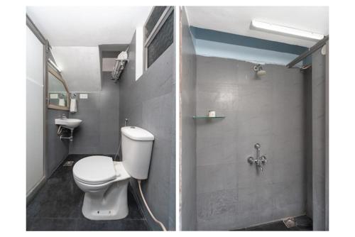 a bathroom with a white toilet and a shower at Grace Residency in Puducherry Airpoert
