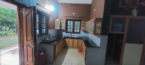 a small kitchen with a sink and a counter at Blooms Aquatica in Kenichira