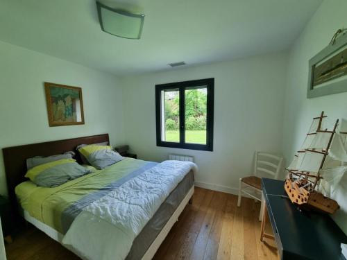 une chambre avec un lit, un bureau et une fenêtre dans l'établissement house with heated pool and jacuzzi, à Soorts-Hossegor