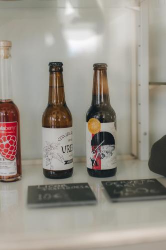three bottles of beer sitting on a counter at Centro Rewilding in Vale de Madeira