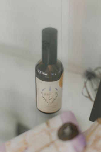 a bottle of oil sitting on top of a table at Centro Rewilding in Vale de Madeira