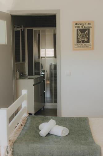 a kitchen with two white towels on the floor at Centro Rewilding in Vale de Madeira