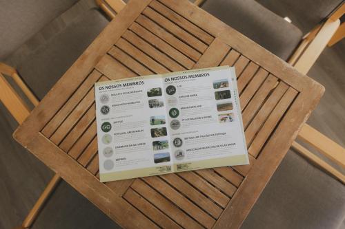 a sign on the back of a wooden chair at Centro Rewilding in Vale de Madeira