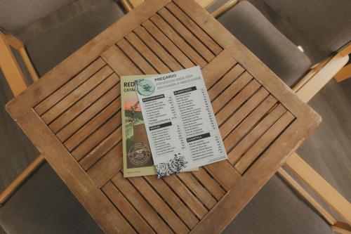 a ticket sitting on top of a wooden chair at Centro Rewilding in Vale de Madeira