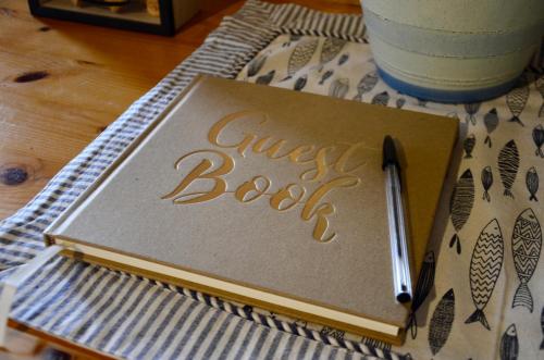 a guest book with a pen on a table at A casa di amici in Vidor