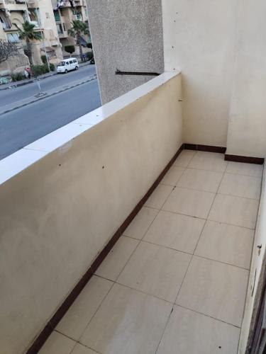 a corner of a room with a tile floor and a window at Blue Horizon Homestay -FOR MEN ONLY- in Dumyāţ al Jadīdah