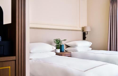a row of white beds in a room at The Lansdowne Kenmare in Kenmare