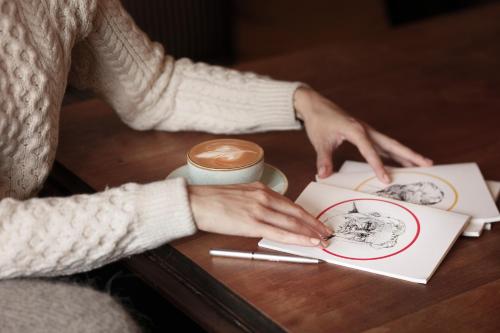 two people sitting at a table with a book at The Lansdowne Kenmare in Kenmare