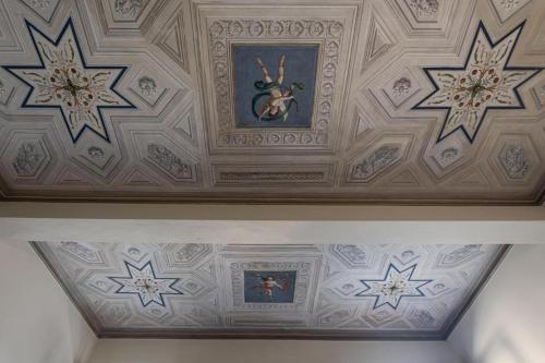 a coffered ceiling with paintings and pictures on it at DUE TORRI 1 LUXURY PALACE- BEDINBOLOGNAcentro in Bologna