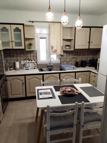 a kitchen with a table and chairs and a counter top at Dora's House in Chios