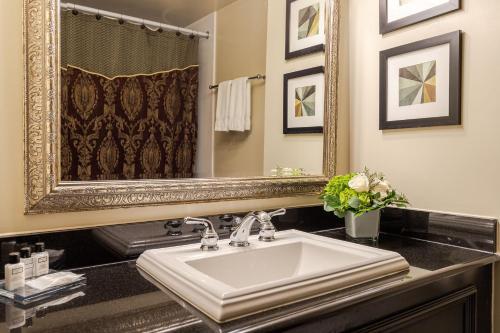 a bathroom with a sink and a mirror at Old Stone Inn Boutique Hotel in Niagara Falls